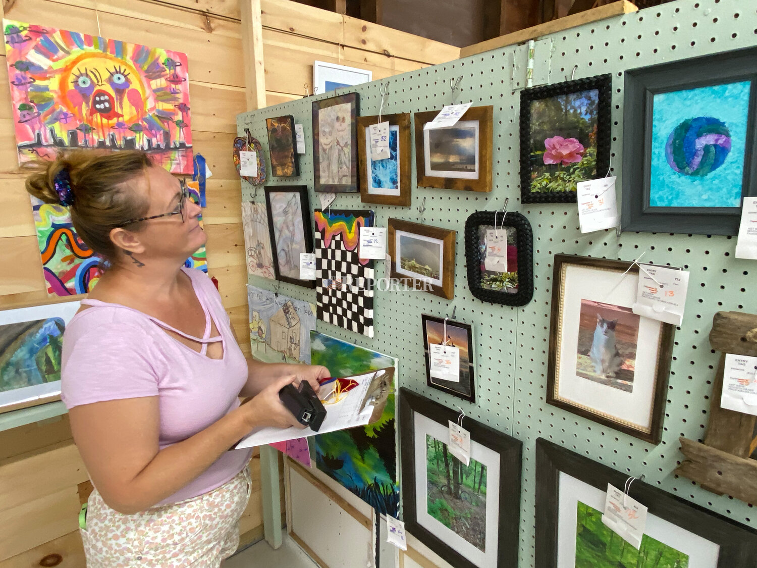 Art Department Superintendent Nicky Carr reviewed artwork in the youth category and awarded ribbons following judging, Sunday, Aug. 13.